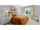 Cozy primary bedroom featuring a plush bed with decorative pillows, bedside lamps, and a large window at 288 Watersglen Dr, Summerville, SC 29486