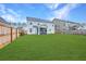 Large, well-maintained backyard with a wooden fence and a view of the home at 300 Saxony Loop, Summerville, SC 29486