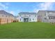 Expansive backyard with a lush lawn, wooden fence, and a screened-in porch at 300 Saxony Loop, Summerville, SC 29486