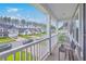 Inviting balcony offers neighborhood views with a comfortable chair and a cozy throw at 300 Saxony Loop, Summerville, SC 29486