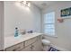 Bright bathroom with a neutral color palette, ample counter space, and a window at 300 Saxony Loop, Summerville, SC 29486