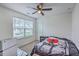 Well-lit bedroom featuring ceiling fan, large window, and unique bedding at 300 Saxony Loop, Summerville, SC 29486