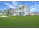 Attractive two-story home with a large, lush green lawn and inviting double porches at 300 Saxony Loop, Summerville, SC 29486