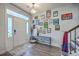 Bright foyer with a decorative wall, wood floors, and a view of the staircase at 300 Saxony Loop, Summerville, SC 29486