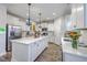 A stylish kitchen features an island with bar stool seating, stainless steel appliances, and plenty of storage at 300 Saxony Loop, Summerville, SC 29486