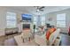 Sun-filled living room with a fireplace, a ceiling fan, and modern decor, perfect for relaxing or entertaining at 300 Saxony Loop, Summerville, SC 29486
