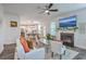 Bright and airy living room features a fireplace, ceiling fan, and open floor plan to the kitchen at 300 Saxony Loop, Summerville, SC 29486
