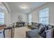 Cozy living room with a plush sofa, piano, and large windows with natural light at 300 Saxony Loop, Summerville, SC 29486