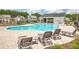 Community pool featuring a pool house, playground, and ample seating for residents at 300 Saxony Loop, Summerville, SC 29486