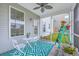 Screened-in porch with a small table and chairs, adorned with potted plants at 300 Saxony Loop, Summerville, SC 29486