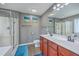 Bathroom featuring double sinks, wooden vanity, shower with glass doors, and decorative art at 3055 Nantuckett Ave, North Charleston, SC 29420