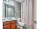 Bathroom features a vanity, toilet, mirror and shower with a floral pattern shower curtain at 3055 Nantuckett Ave, North Charleston, SC 29420