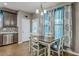 Dining area features hardwood floors, decorative curtains, and easy access to the kitchen at 3055 Nantuckett Ave, North Charleston, SC 29420
