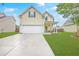 Charming two-story home featuring an attached two car garage and a well-manicured front yard at 3055 Nantuckett Ave, North Charleston, SC 29420