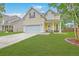 Charming two-story home featuring an attached two car garage, a well-manicured front yard and covered porch at 3055 Nantuckett Ave, North Charleston, SC 29420