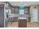 Kitchen with stainless steel appliances, an island, wooden floors, mosaic backsplash, and dark wood cabinetry at 3055 Nantuckett Ave, North Charleston, SC 29420