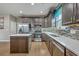 Modern kitchen with stainless steel appliances, tile backsplash, quartz countertop, island, and updated cabinets at 3055 Nantuckett Ave, North Charleston, SC 29420