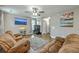 Comfortable living room features hardwood floors, a ceiling fan, and two reclining sofas at 3055 Nantuckett Ave, North Charleston, SC 29420