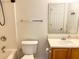 Well-lit bathroom with a tub-shower, toilet, vanity, and large mirror at 311 Dupont Way, Summerville, SC 29485