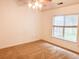 Carpeted bedroom with a ceiling fan and natural light streaming through the window at 311 Dupont Way, Summerville, SC 29485
