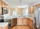 Well-lit kitchen with stainless steel appliances, wooden cabinets, and a functional layout at 311 Dupont Way, Summerville, SC 29485