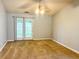 Spacious carpeted room with fan and light fixture, along with glass paneled doors to the outside at 311 Dupont Way, Summerville, SC 29485