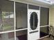 Enclosed screened porch with decorative white door at 311 Dupont Way, Summerville, SC 29485