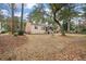 Rear exterior of home with a screened porch, brick details, lawn and lush surroundings at 315 Clubview Rd, Summerville, SC 29485