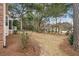 Expansive backyard with mature trees, mulch beds, a section of the home and partial privacy fence at 315 Clubview Rd, Summerville, SC 29485