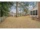 Large backyard featuring a tree-lined perimeter, an enclosed patio, and views of neighboring houses at 315 Clubview Rd, Summerville, SC 29485