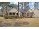 Lovely brick home featuring a cozy front porch and manicured landscaping at 315 Clubview Rd, Summerville, SC 29485