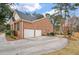 Spacious brick home with two-car garage and large concrete driveway, surrounded by mature trees and landscaping at 315 Clubview Rd, Summerville, SC 29485
