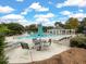 A refreshing community pool with plenty of seating with a table and chairs and sun loungers around the area at 315 Clubview Rd, Summerville, SC 29485