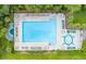 Aerial shot of a large community swimming pool with lounge chairs and tables, perfect for relaxation at 315 Clubview Rd, Summerville, SC 29485