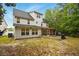 Back exterior of home features a screened porch and spacious backyard at 317 Sabal Palmetto Ct, Moncks Corner, SC 29461