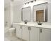 A modern bathroom features dual vanities, sleek black fixtures, and a tub/shower combo at 317 Sabal Palmetto Ct, Moncks Corner, SC 29461