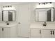 Bathroom featuring double sinks, black hardware and bright white cabinets at 317 Sabal Palmetto Ct, Moncks Corner, SC 29461