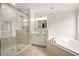 The bathroom features a glass-enclosed shower, soaking tub, and neutral color palette at 317 Sabal Palmetto Ct, Moncks Corner, SC 29461