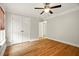 Comfortable bedroom featuring ceiling fan and neutral walls with bright hardwood floors at 317 Sabal Palmetto Ct, Moncks Corner, SC 29461