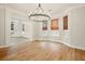 Hardwood floors in the dining room are highlighted by a stylish chandelier at 317 Sabal Palmetto Ct, Moncks Corner, SC 29461