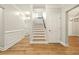 Hallway and staircase featuring hardwood floors and neutral paint at 317 Sabal Palmetto Ct, Moncks Corner, SC 29461