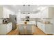 Spacious kitchen with a large center island, stainless steel appliances, and white cabinets at 317 Sabal Palmetto Ct, Moncks Corner, SC 29461