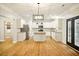 Bright, open kitchen featuring white cabinets, granite countertops, a center island, and stainless steel appliances at 317 Sabal Palmetto Ct, Moncks Corner, SC 29461