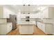 Bright eat-in kitchen with white cabinetry, stainless appliances and granite countertops at 317 Sabal Palmetto Ct, Moncks Corner, SC 29461