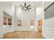 Open concept living room featuring hardwood floors, neutral paint, and stairwell at 317 Sabal Palmetto Ct, Moncks Corner, SC 29461