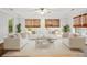 Inviting living room with white furniture, plants, modern decor, and lots of natural light at 317 Sabal Palmetto Ct, Moncks Corner, SC 29461