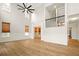 Open concept living room with tons of natural light and access to the stairwell at 317 Sabal Palmetto Ct, Moncks Corner, SC 29461