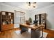 Office featuring hardwood floors, built-in bookshelves, modern decor, and lots of light at 317 Sabal Palmetto Ct, Moncks Corner, SC 29461