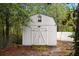 White outbuilding in the backyard offers additional storage space at 317 Sabal Palmetto Ct, Moncks Corner, SC 29461