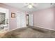 Cozy bedroom with pink walls, a ceiling fan, closet and an adjoining bathroom at 323 Amy Dr, Goose Creek, SC 29445